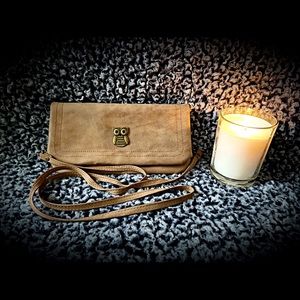 Small brown purse with gold colored accents.